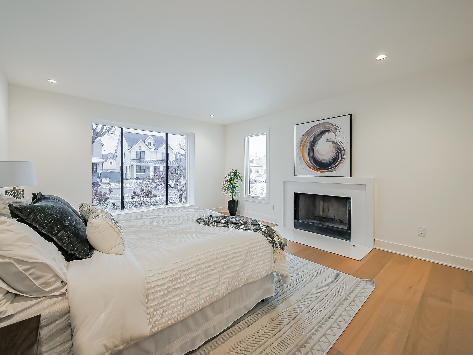 Primary bedroom with fireplace and window