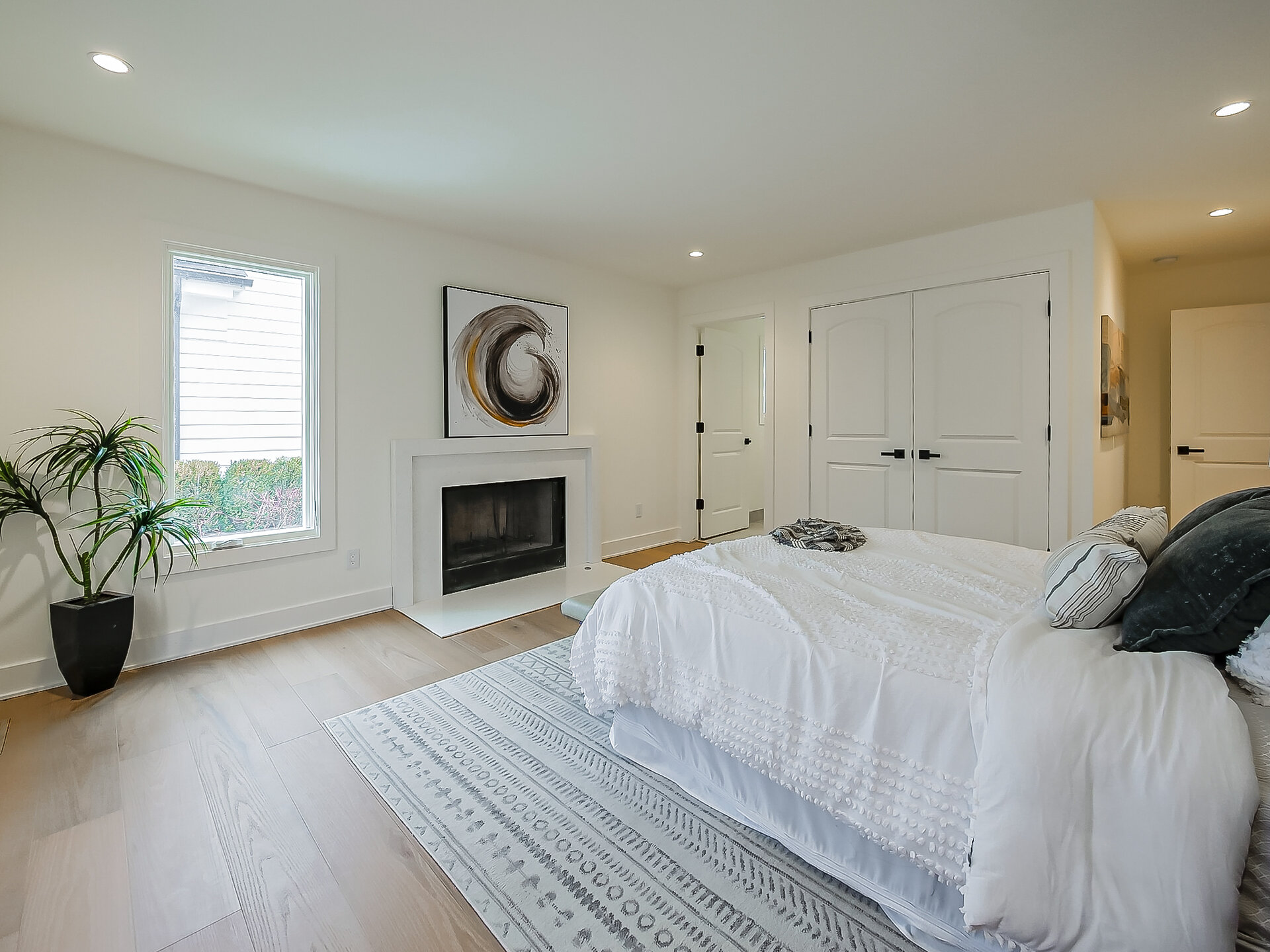 Bedroom with closets and fireplace