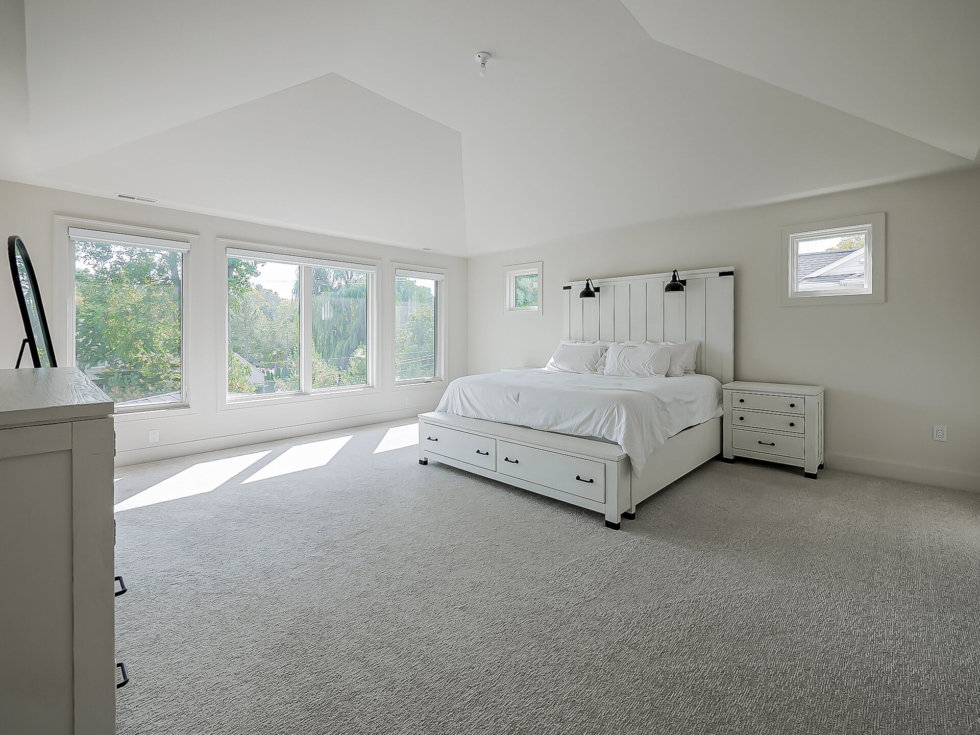 Vaulted primary bedroom with views