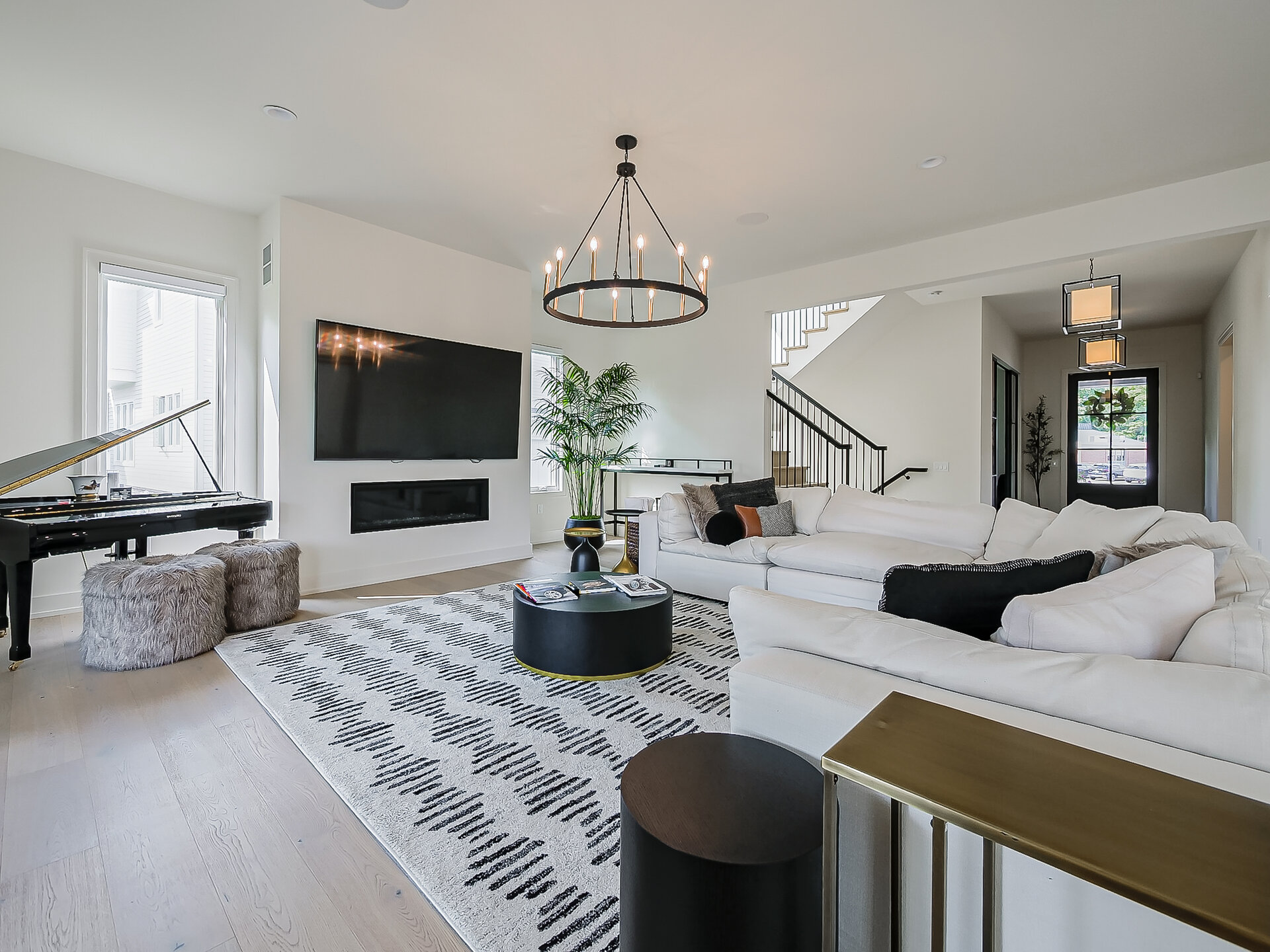 Living room with chandelier and piano